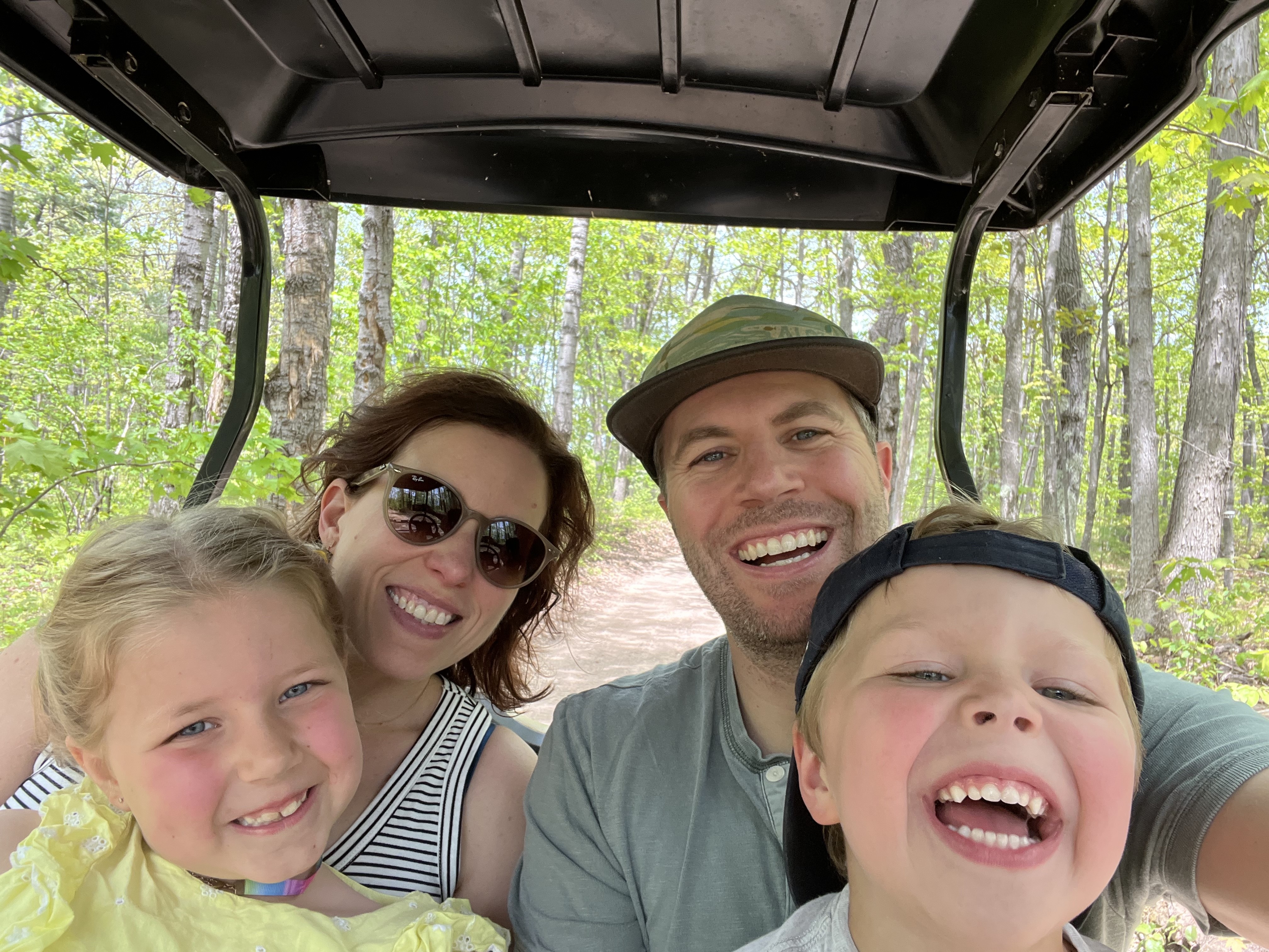 Attorney Melissa Demorest LeDuc with her husband, Jeff, and their two children, Mae and Harley, pose for their annual Memorial Day golf cart selfie, a tradition the family has followed since the children were babies.