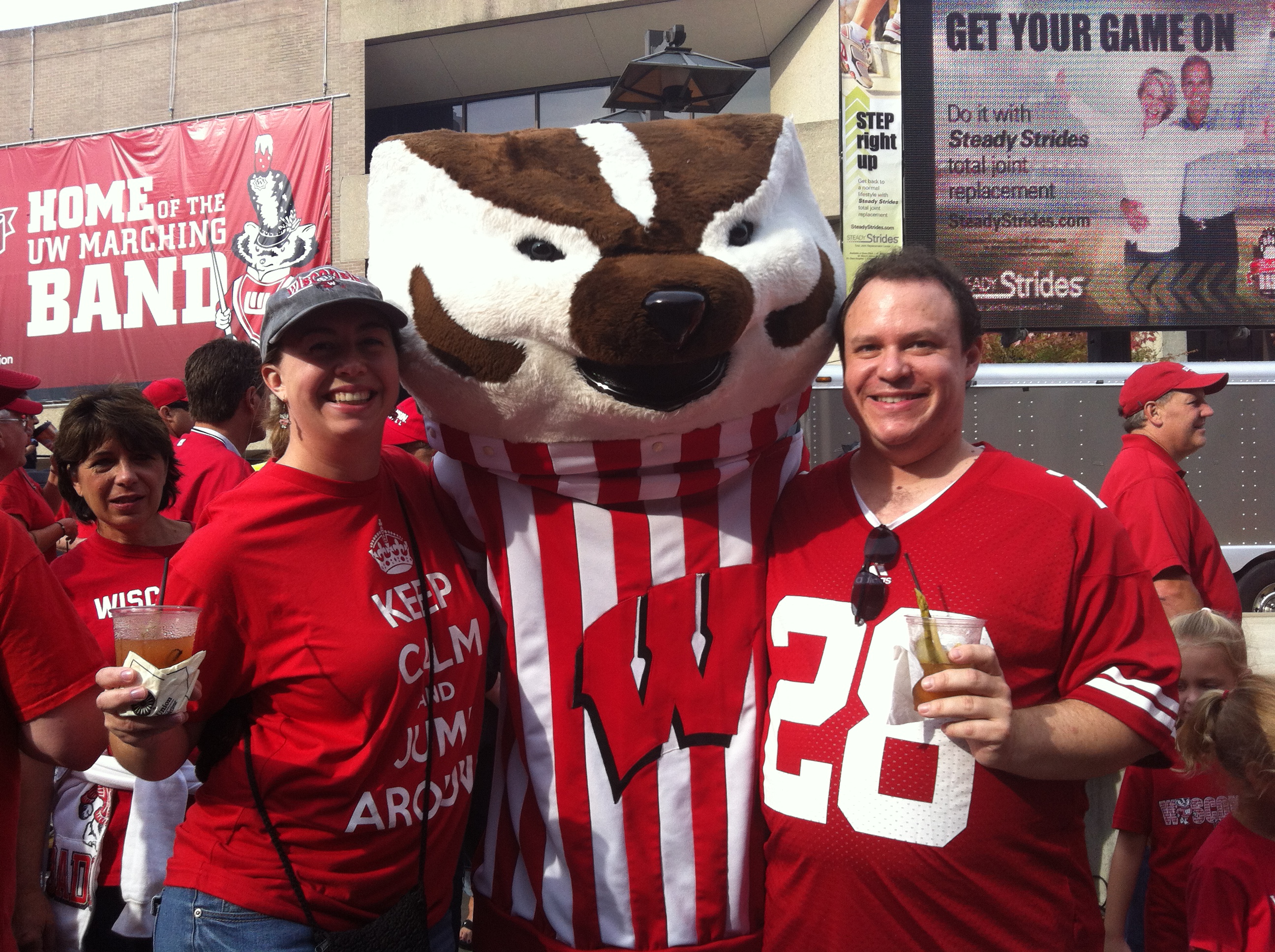 Ryan Billings and his wife Megan pose with the University of Wisconsin football mascot Bucky. Billings is a football fan with a special loyalty for the Greenbay Packers.