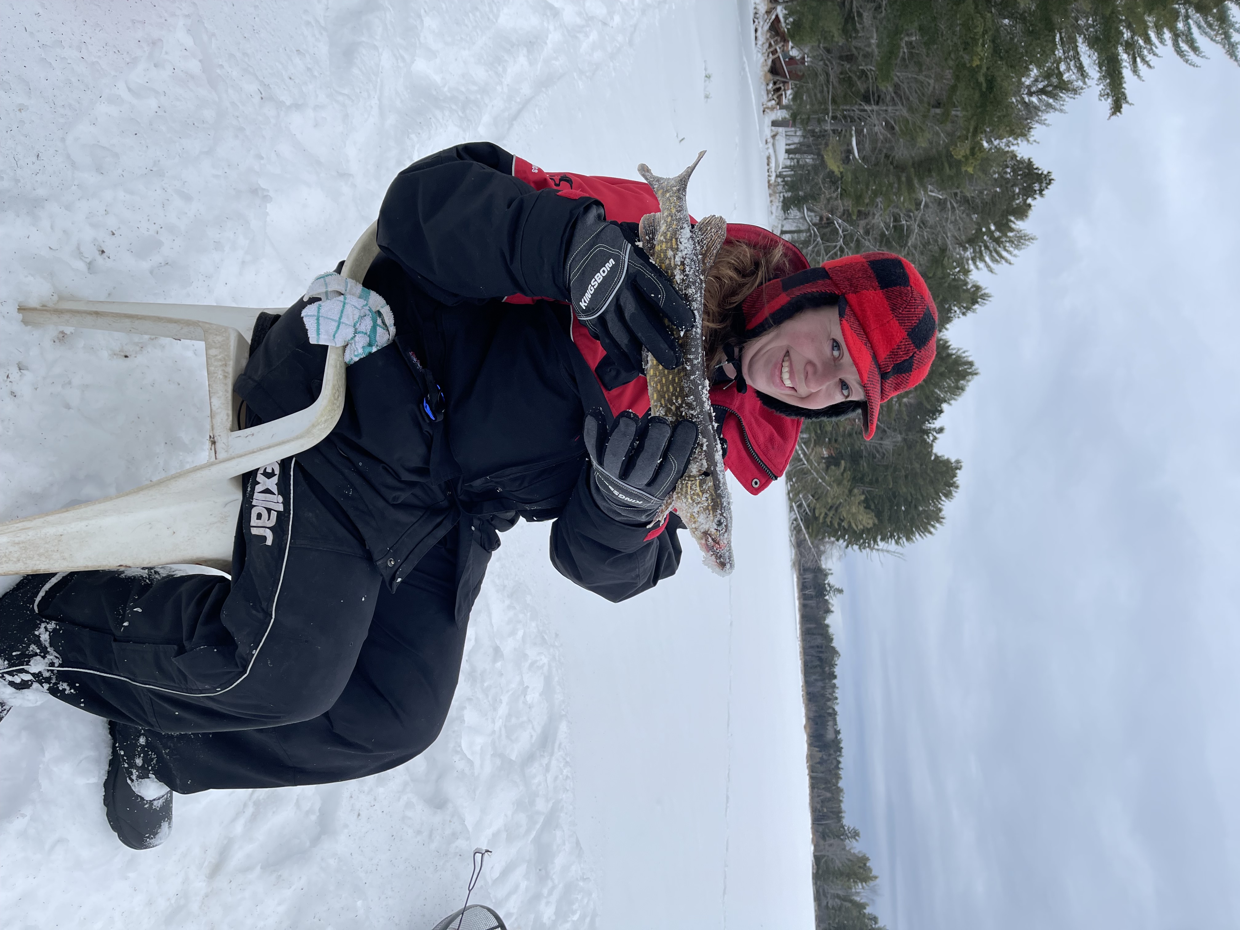 Attorney Ryan Billings and his wife Megan are ice fishing enthusiasts. Megan proudly shows off a catch while ice fishing.