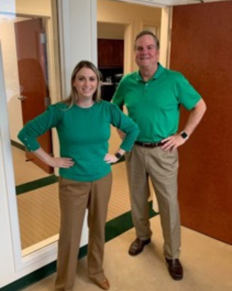 Heather Stover and firm co-founder Tim Sullivan unintentionally in matching outfits at work.