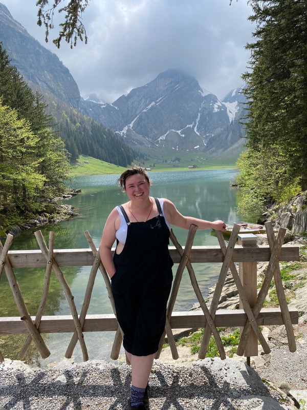 Attorney Elissa Niccum at Seealpsee, a lake in the Alpstein range in Switzerland. Less than an hour after the photo was taken it started thundering and hailing, but the sunshine was beautiful while it lasted