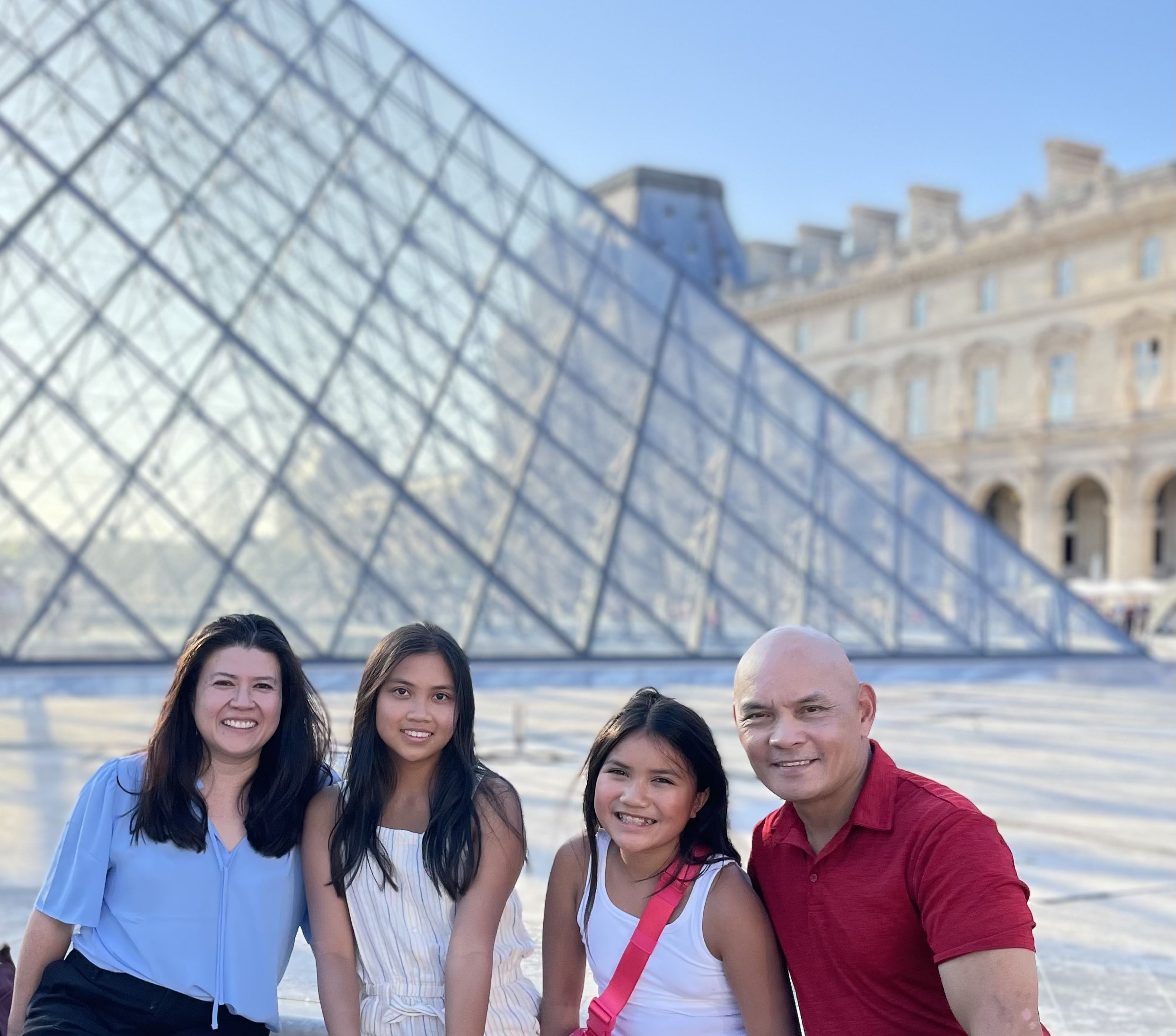 Ed Tugade and his family -- wife, Anna, and daughters, Audrey and Katherine -- at the Louvre in Paris.