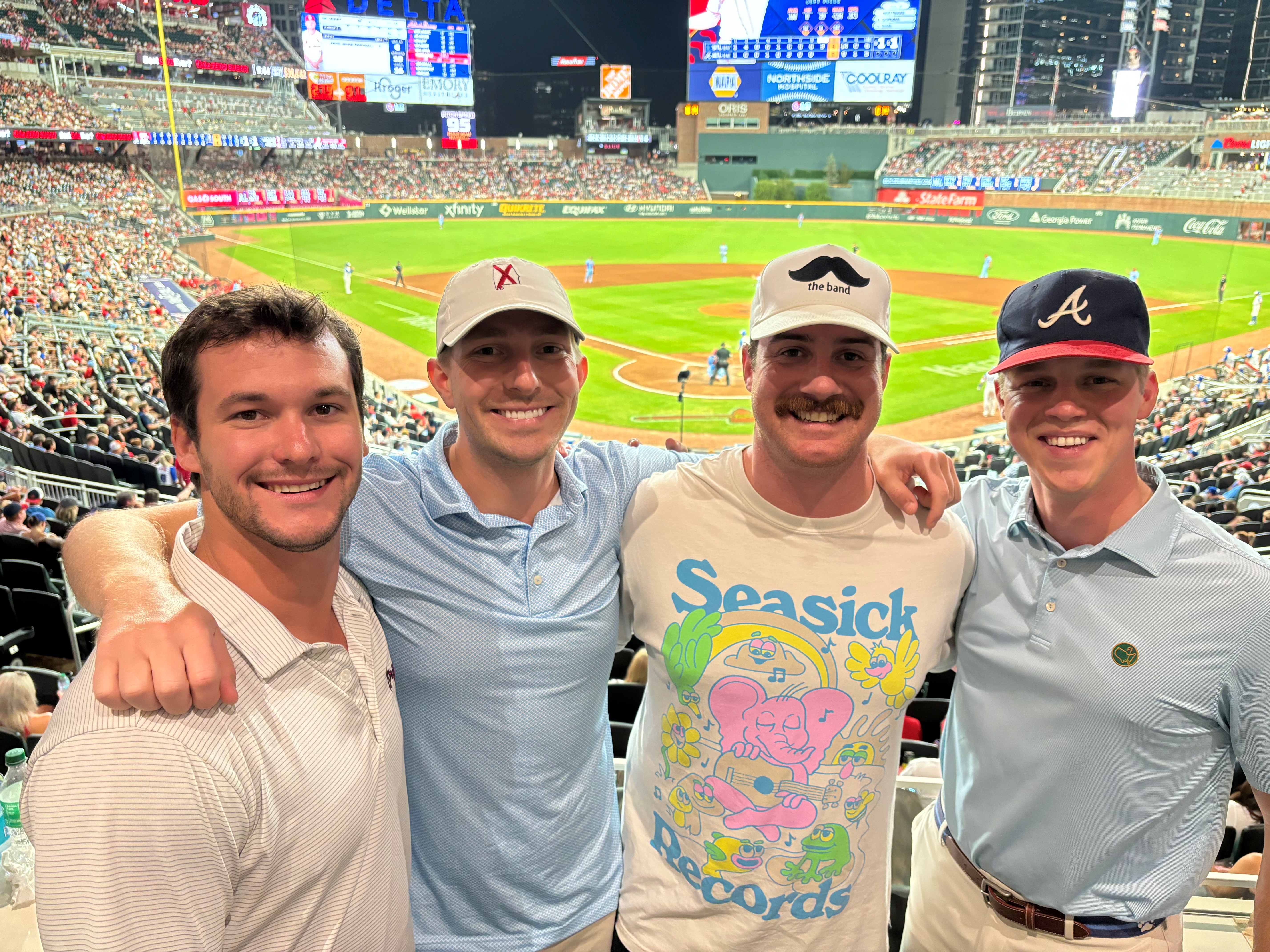 Wilson (second from left), who still plays soccer, basketball and golf,  catches an Atlanta Braves game with friends.