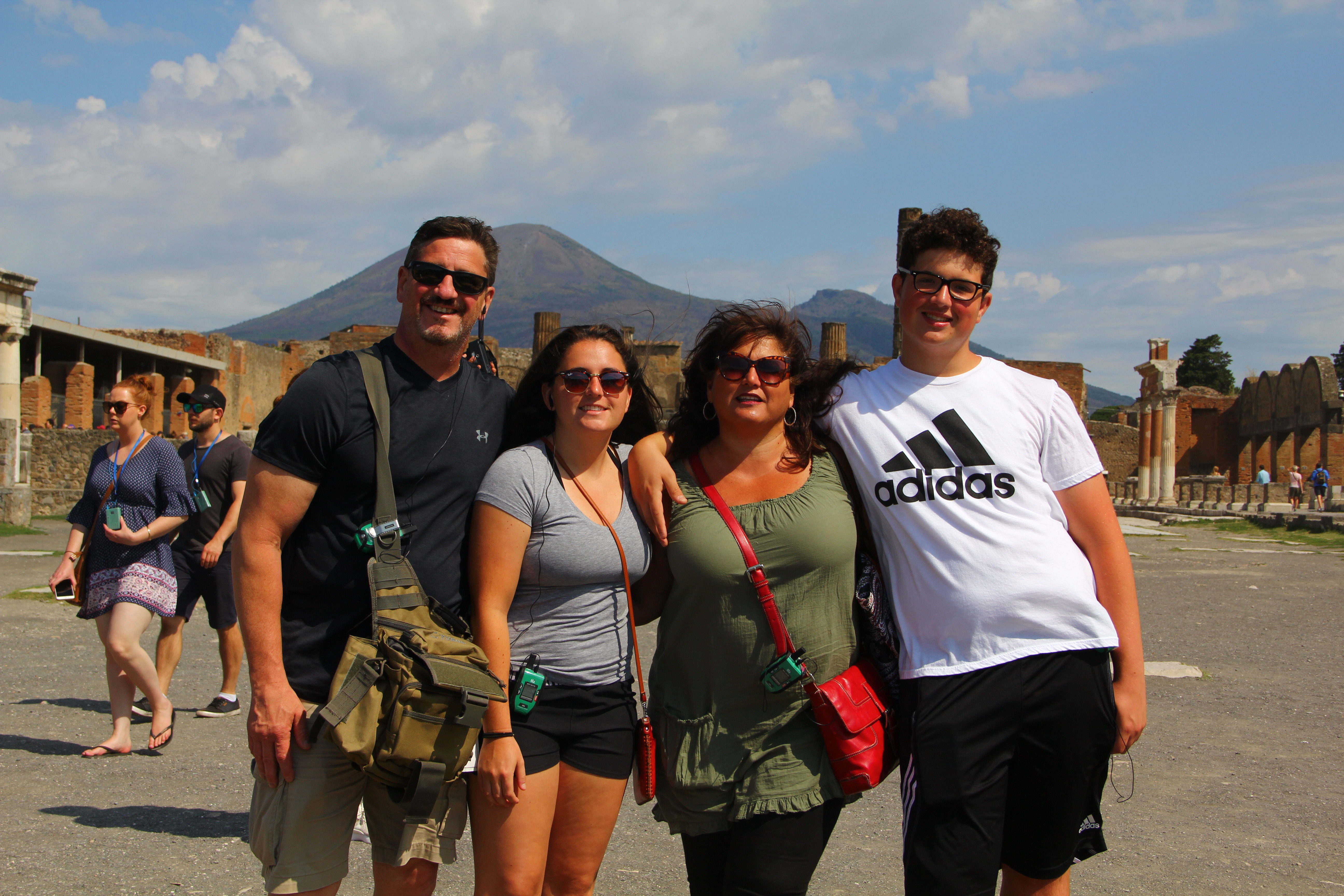 Taylor with her parents and brother on a tour of Pompeii, with Mt. Vesuvius in the background.