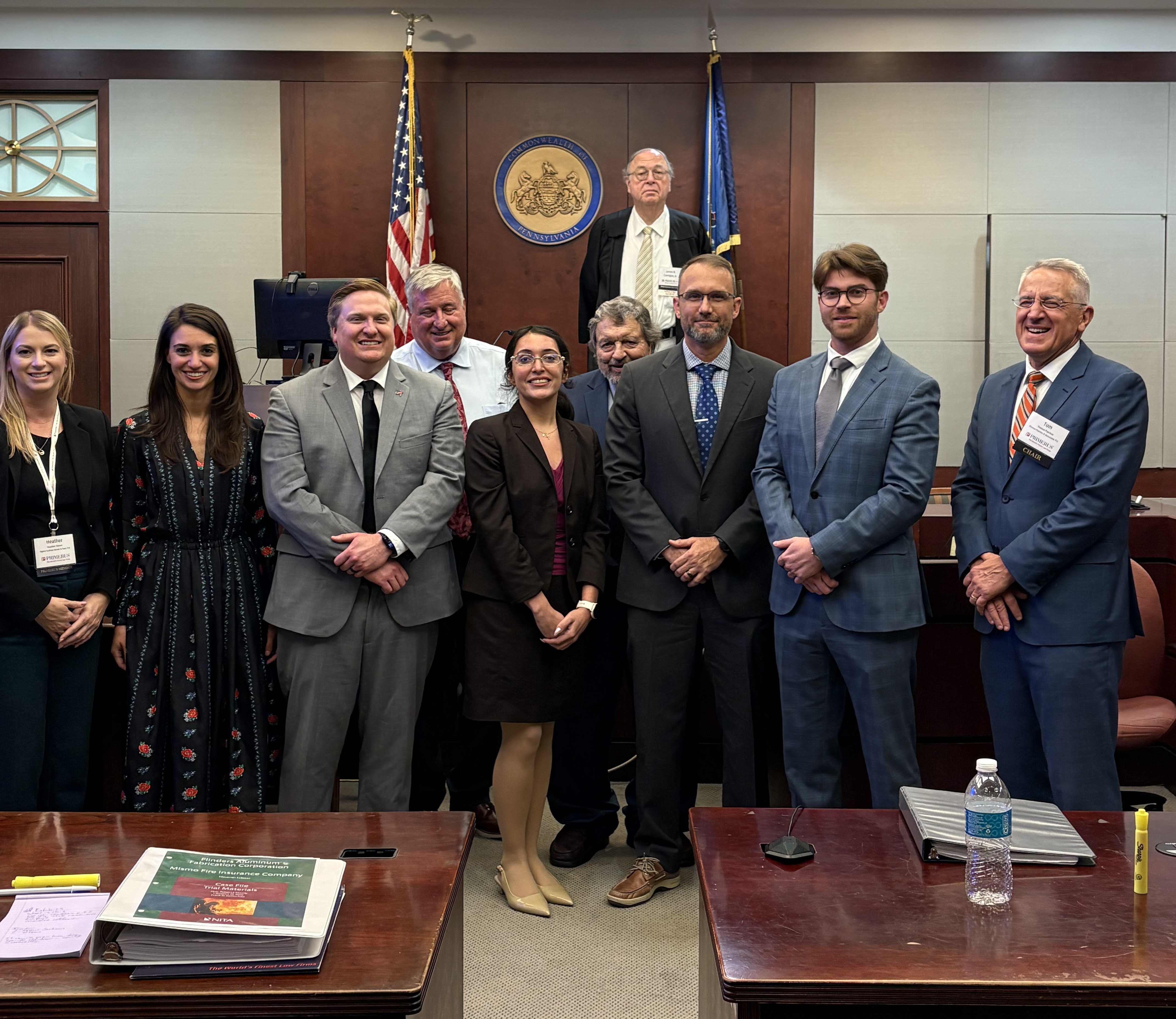 Some of the Primerus members who attended the 2025 Primerus Trial Skills Academy mock trial event. (Front Row L-R: Heather Stover, Ilana Linder, Andrew Smith, Robert Brown, Sophia Alvarenga, Gary Shockey, Lance Duroni, Richard Schwerdtfeger, and Thomas Paschos; Back Row: James Corrigan, Jr.)
